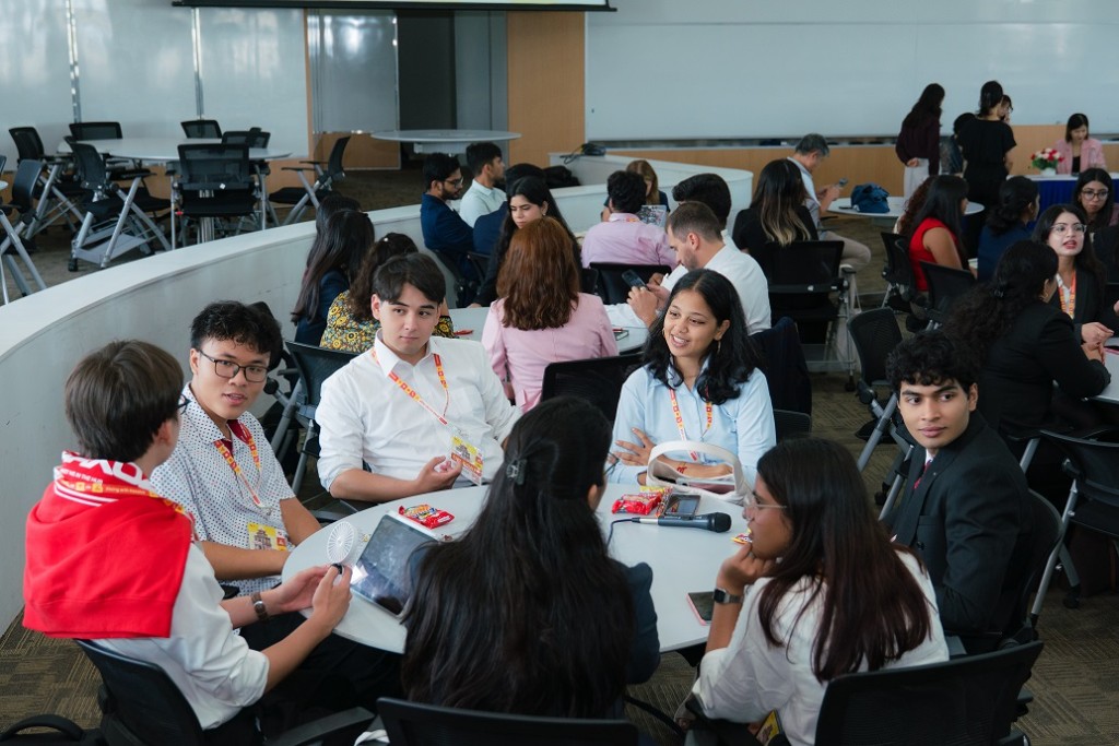 Workshop groups practicing at round tables
