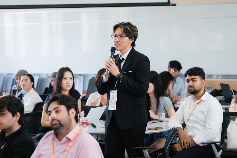 Learner speaking with a microphone in a workshop